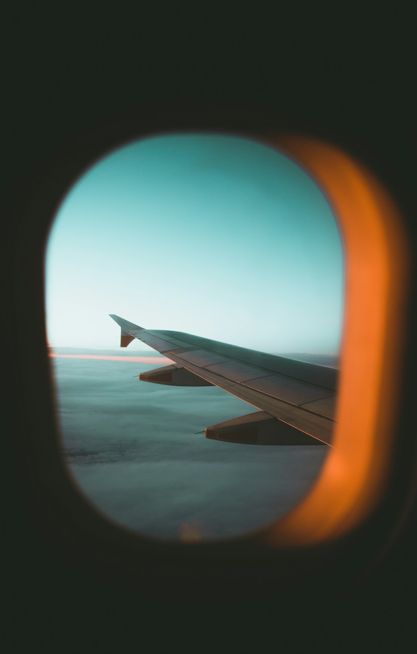 Aircraft wing above clouds